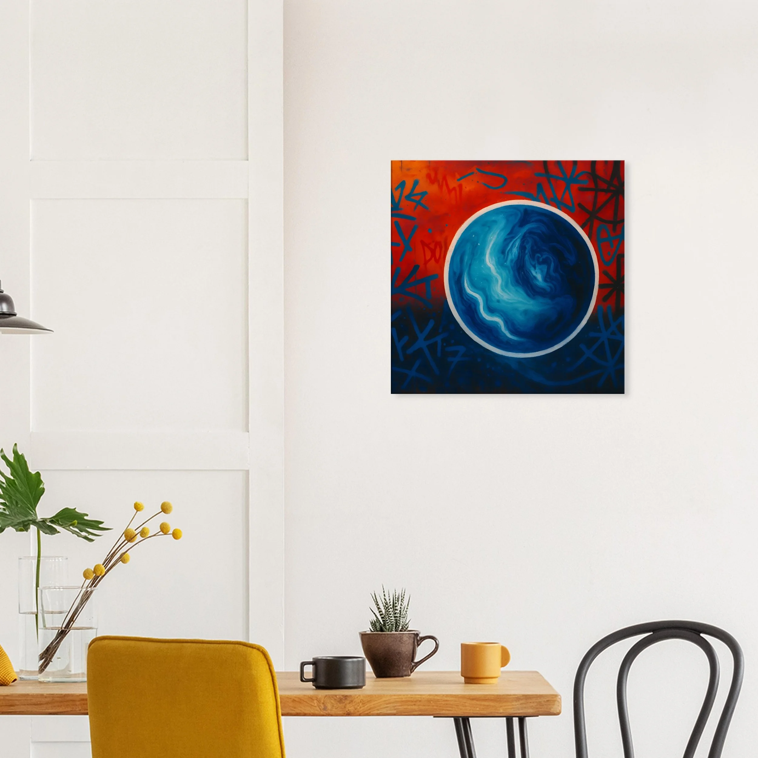 A painting of a blue swirling planet with red and blue graffiti background on a white wall in a modern dining room.