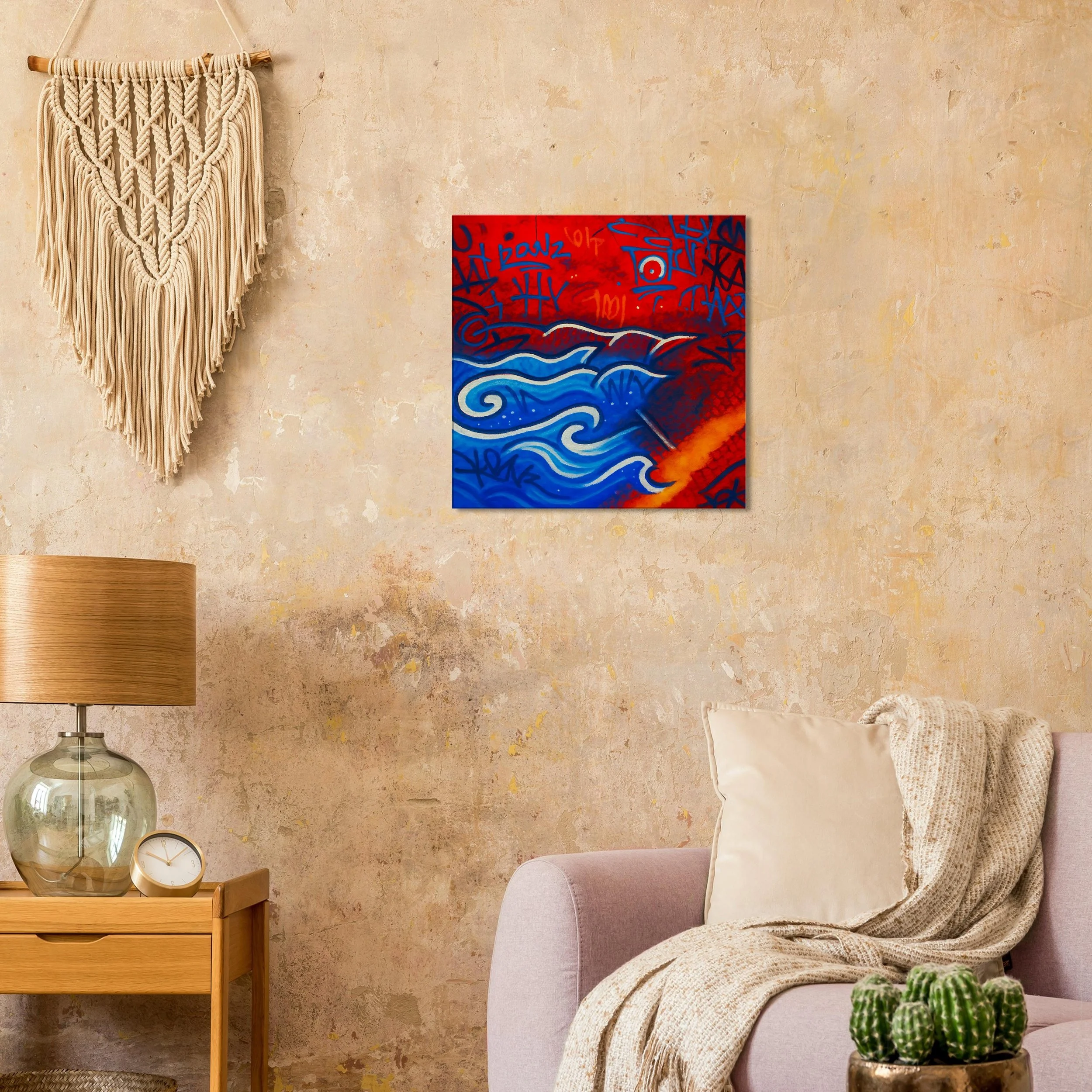 Living room with beige textured wall, beige sofa with light pillow and knitted blanket, wooden side table with a glass lamp and small clock, wall hanging with macrame design, colorful abstract art painting of blue waves and red background, and green 