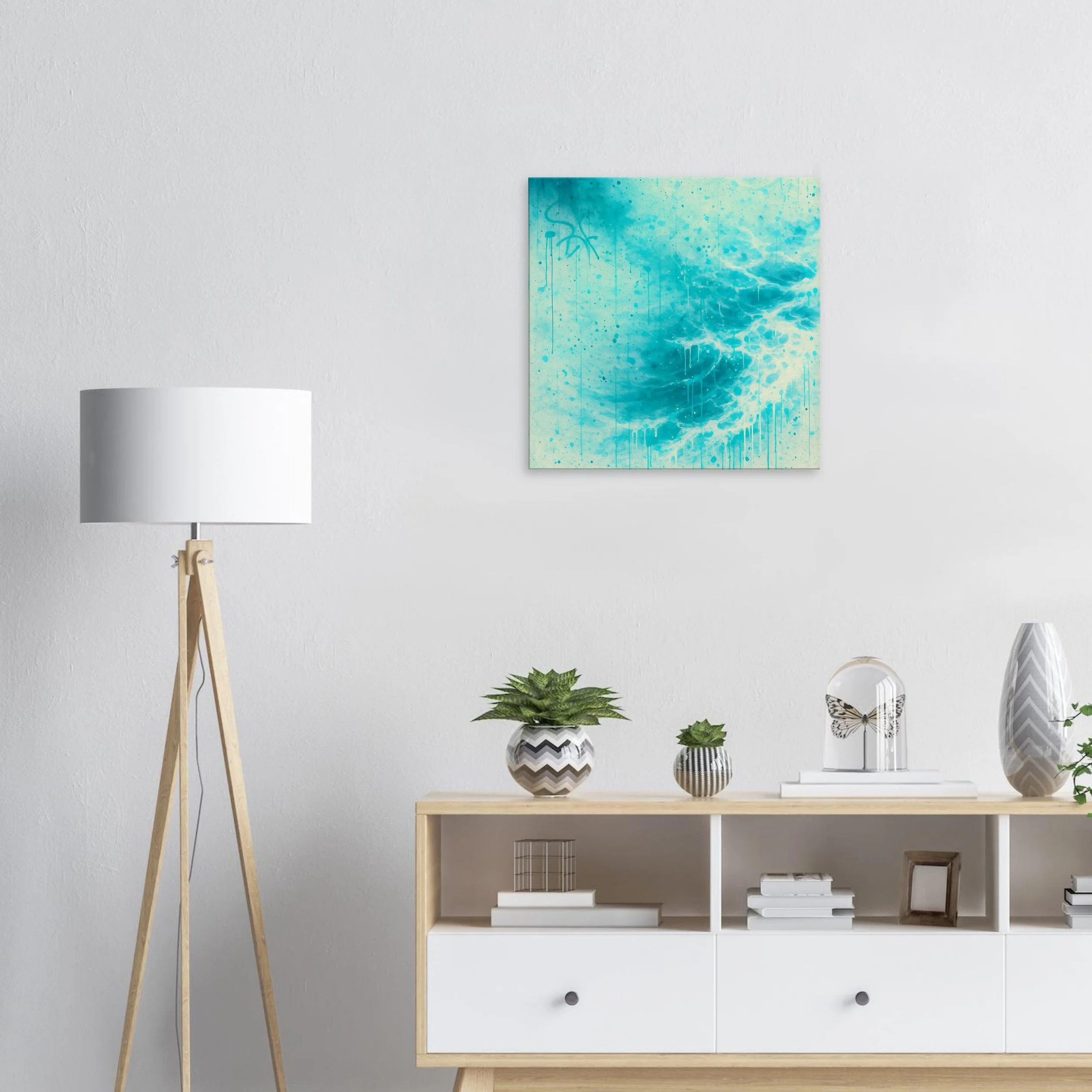 Minimalist living room with a white wall, a modern wooden floor lamp, a light wood and white console table decorated with potted plants, books, and decorative objects, and an abstract blue and white painting on the wall.
