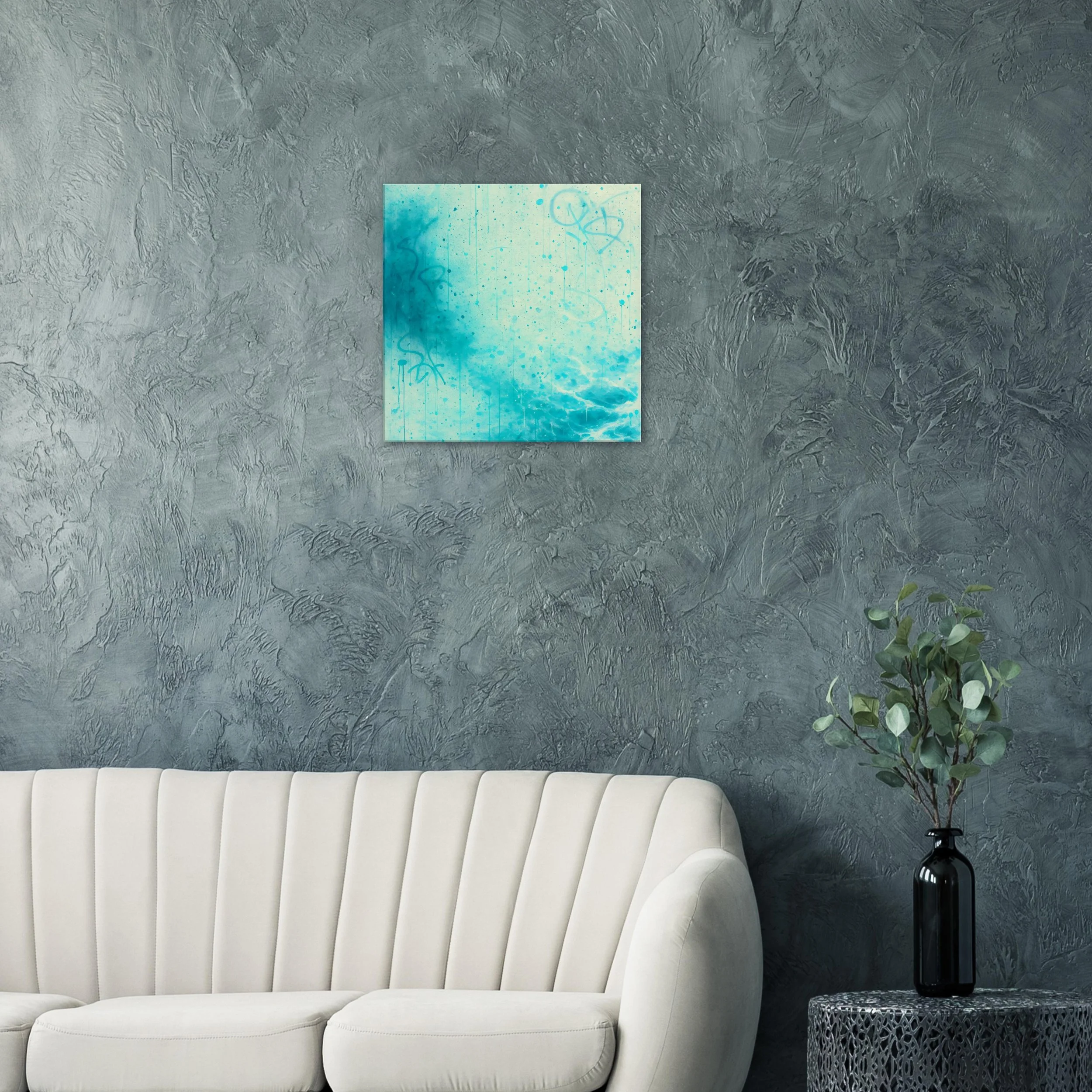 Interior of a living room with textured gray wall, white sofa, and a black vase with green foliage on a small table, artwork depicting an abstract blue scene on the wall.