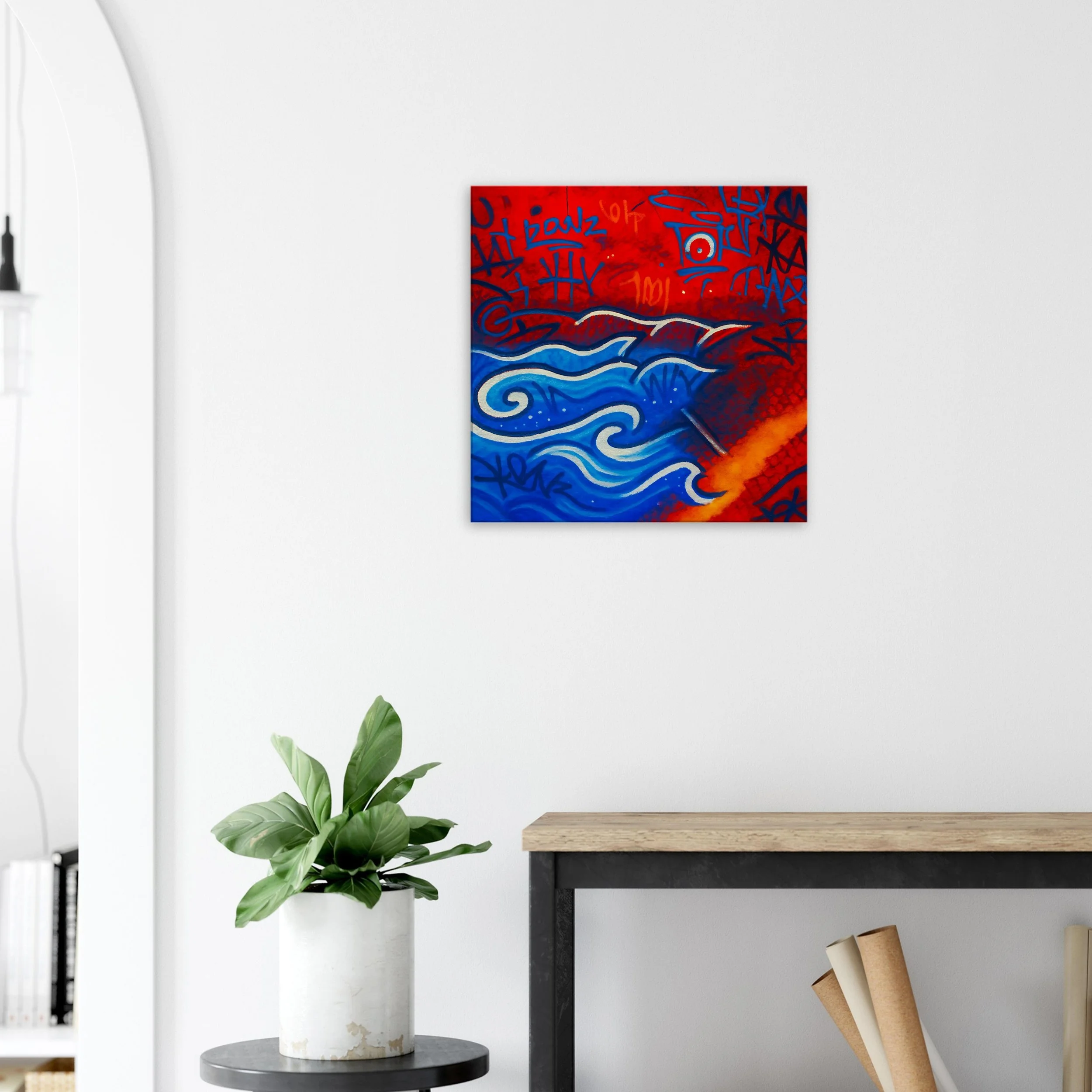 Abstract painting with red, blue, and black graffiti-style markings and swirling patterns on a white wall.
