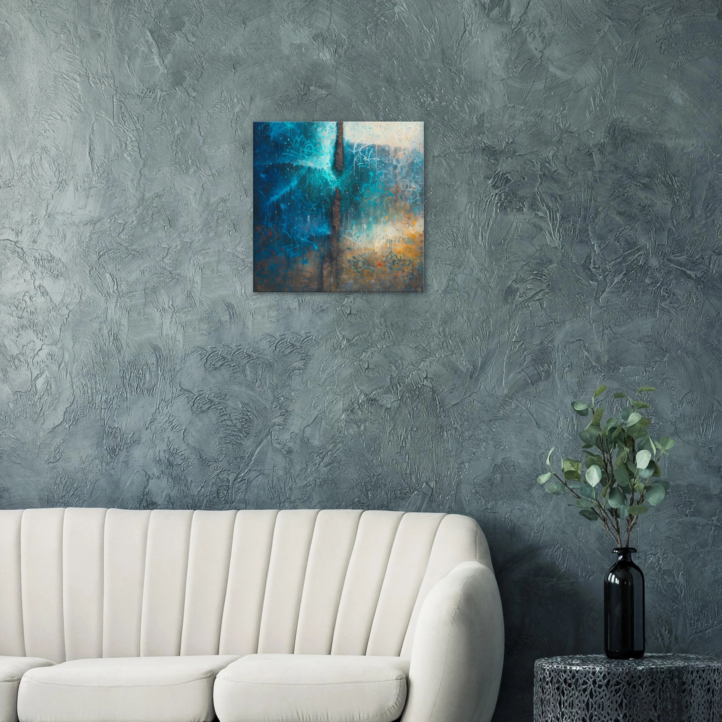 Modern living room with a gray textured wall, white sofa, abstract painting, and a black vase with green foliage on a side table.