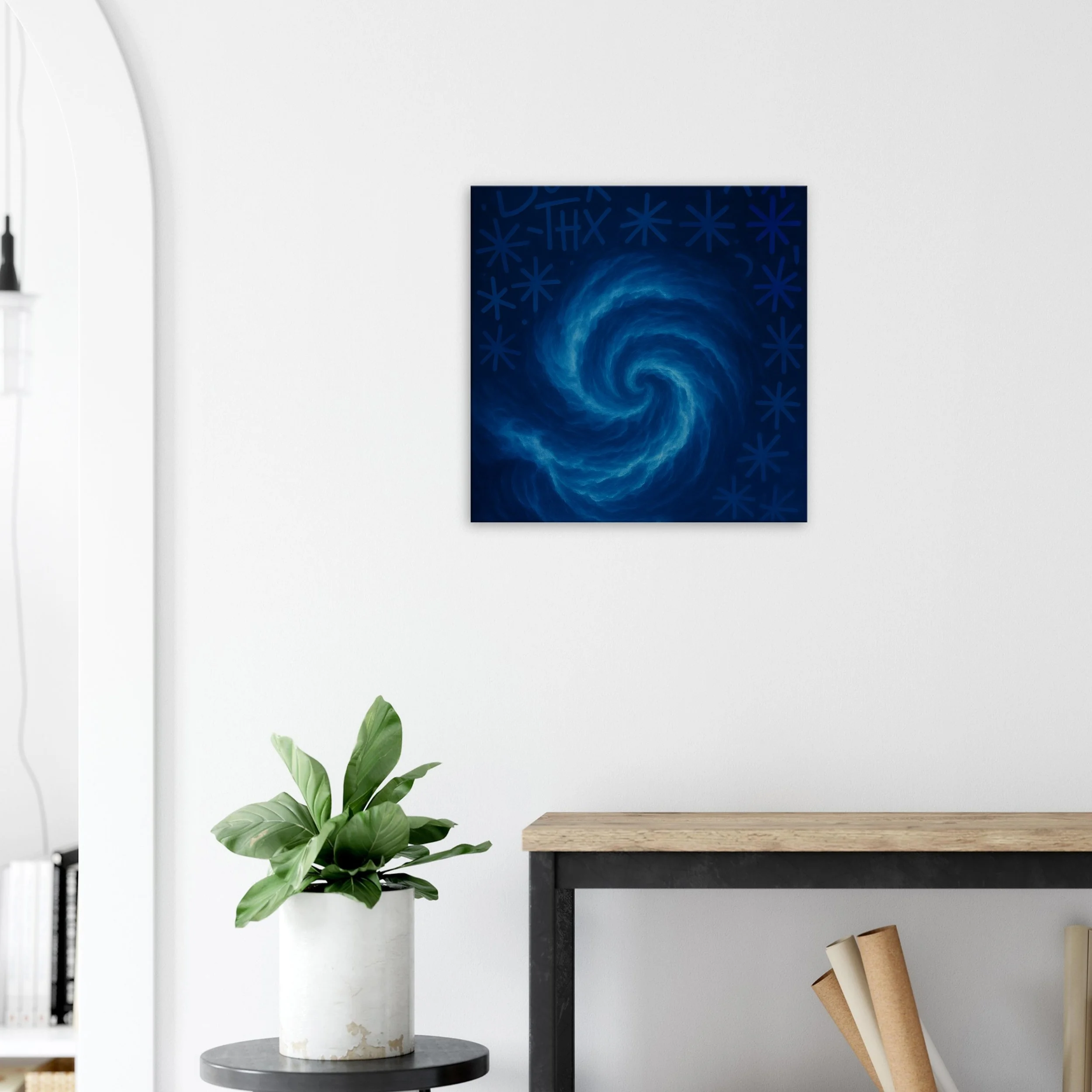 Wall art featuring a swirling galaxy in shades of blue on a white wall.