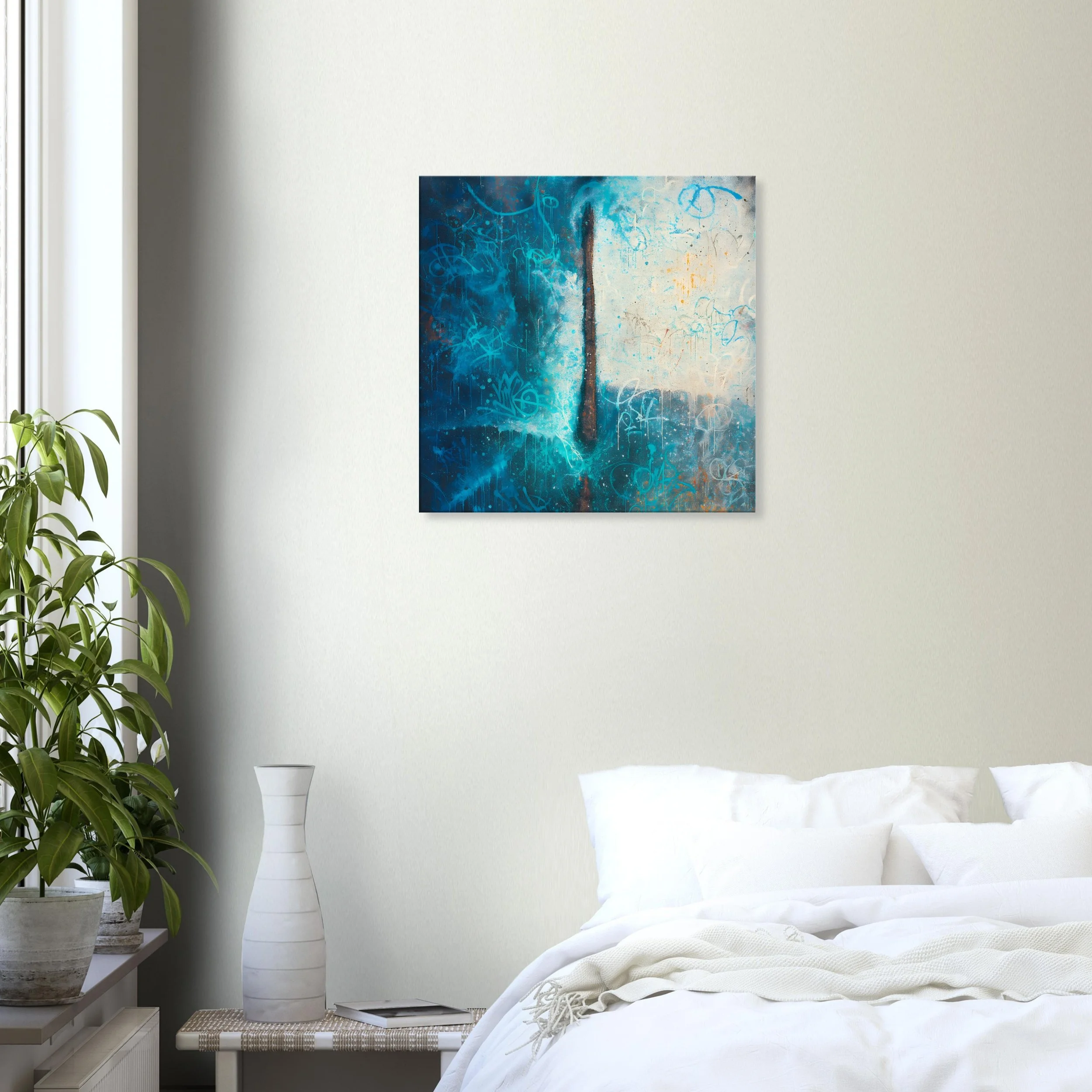 Room with white bedding, green potted plant, abstract blue artwork on cream-colored wall, white vase, and small table.