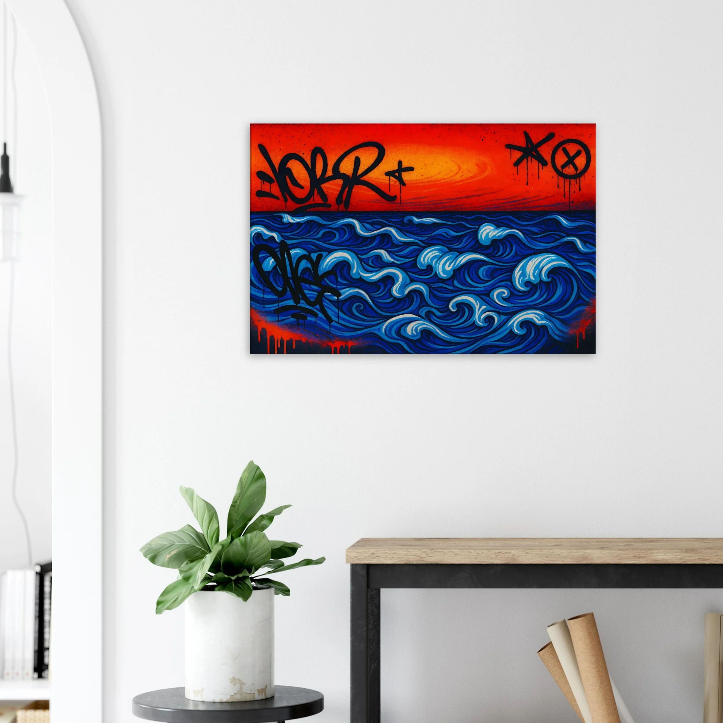 A colorful graffiti art painting of a blue ocean with white waves on a red-orange sky background, hanging on a white wall in a modern interior space.