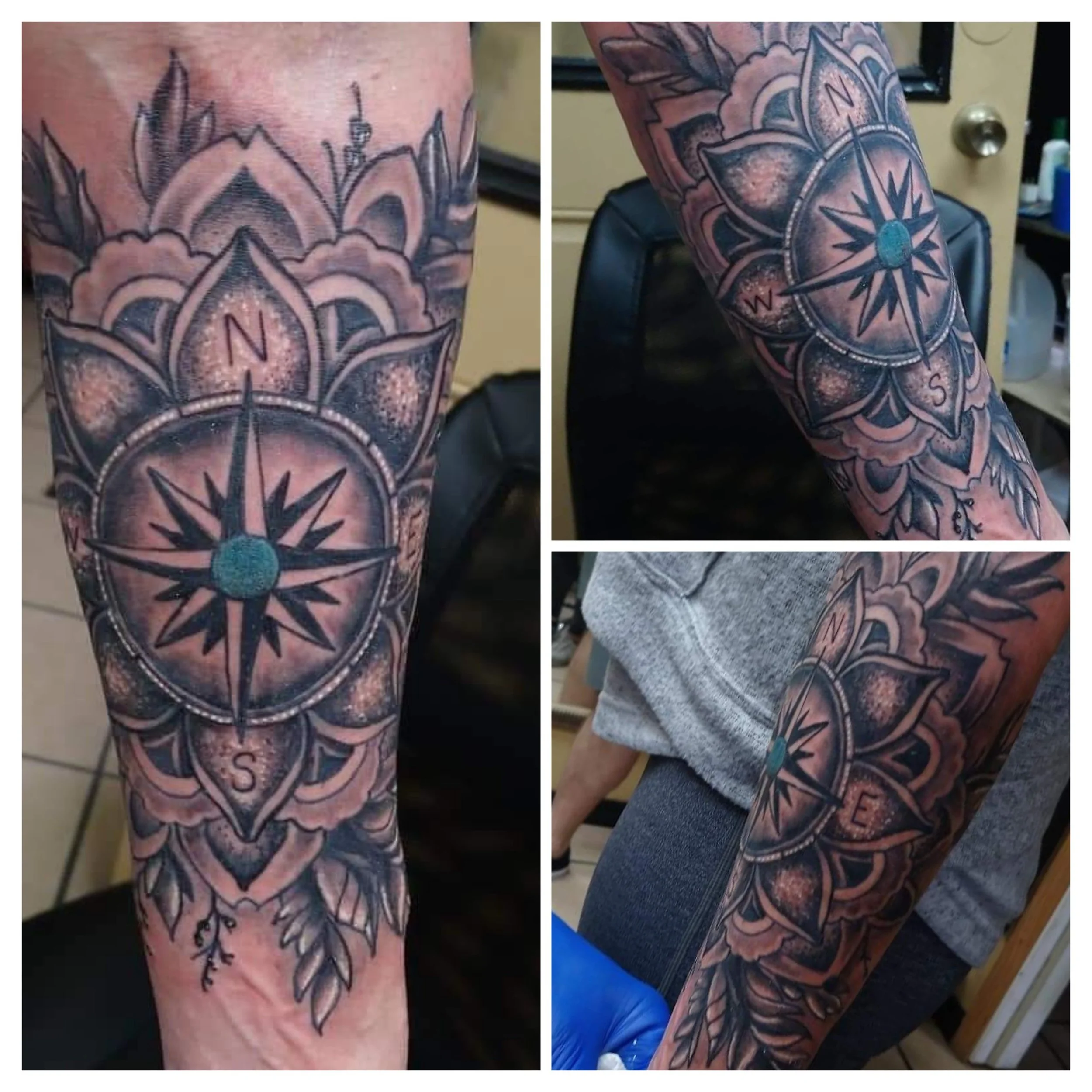 Black and gray sleeve tattoo of a detailed compass rose with a teal center on the person's arm, surrounded by floral and leaf patterns.