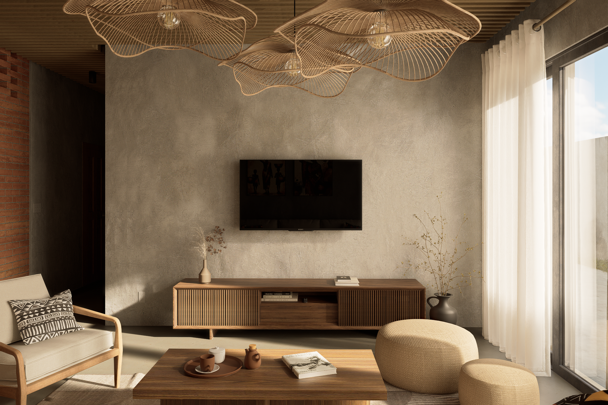 Modern living room with a wood TV console, beige sofa and armchair, patterned pillow, round ottoman, ceramic vases, coffee table with books and ceramics, textured concrete wall, large window with sheer curtains, and artistic wood pendant lights on the ceiling.