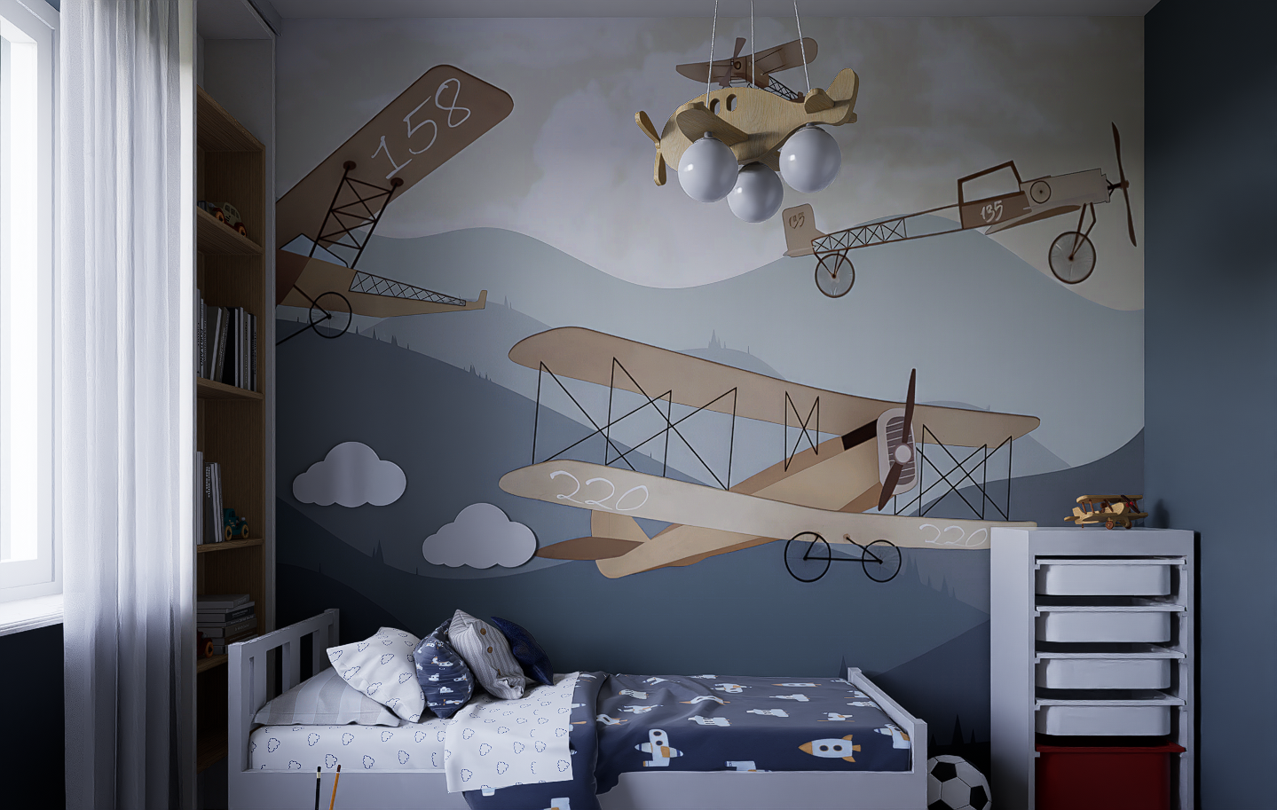 Child's bedroom with space-themed wall mural featuring airplanes, clouds, and mountainous background, white bed with rocket-themed bedding, wooden shelf, white storage unit, and a soccer ball on the floor.