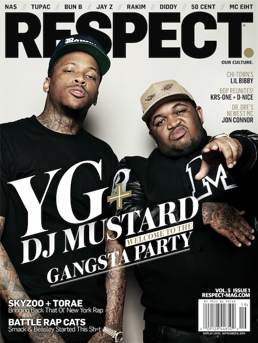 Two men posing for a magazine cover, one wearing a black cap and black t-shirt, the other wearing a beige cap and black sweatshirt.