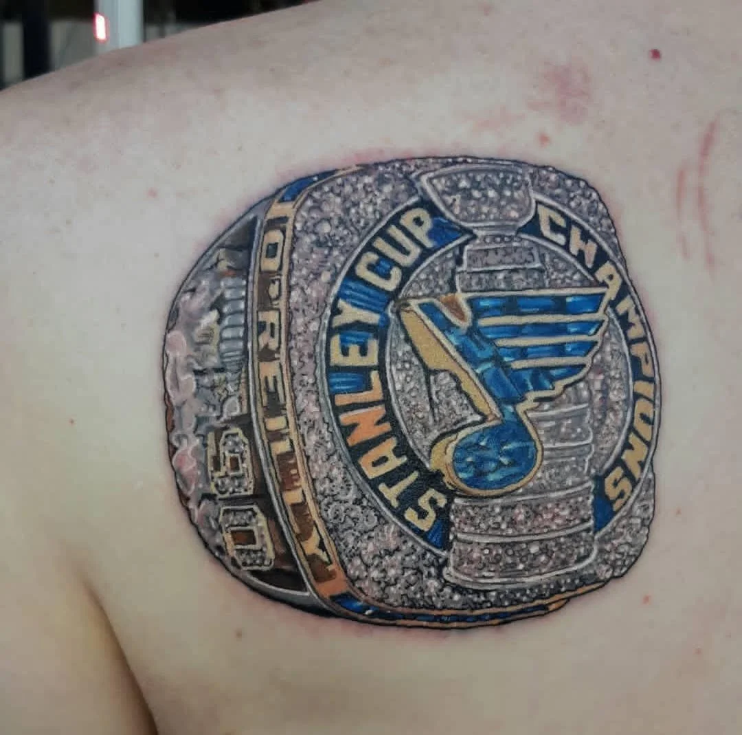 This piece captures the gleaming texture of a championship ring with intricate detailing, metallic shading, and bold team colors. The depth, highlights, and crisp lettering make it look strikingly three-dimensional and full of trophy-style realism.