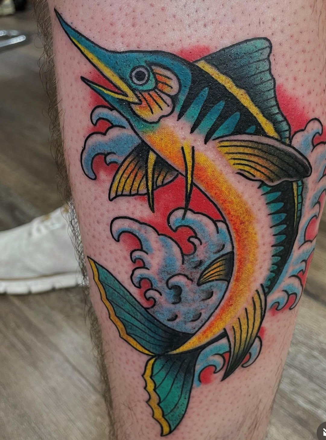 A bold, colorful sailfish leaping through stylized waves. The saturated blues, yellows, and oranges create a striking tropical energy with a classic traditional layout.