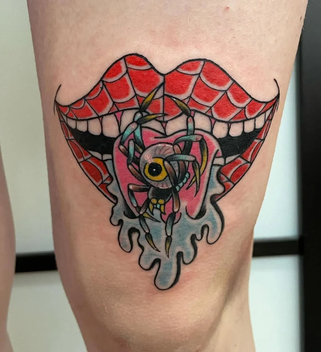 A surreal design featuring red webbed lips with an eyeball spider emerging from the mouth. The mix of horror and pop-art style creates a striking, imaginative visual.