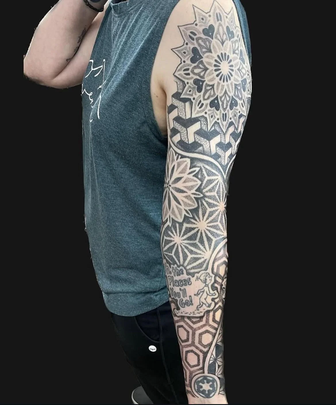 A full sleeve of intricate geometric and mandala-inspired patterns. The precise linework and dot shading showcase balance, symmetry, and technical mastery.