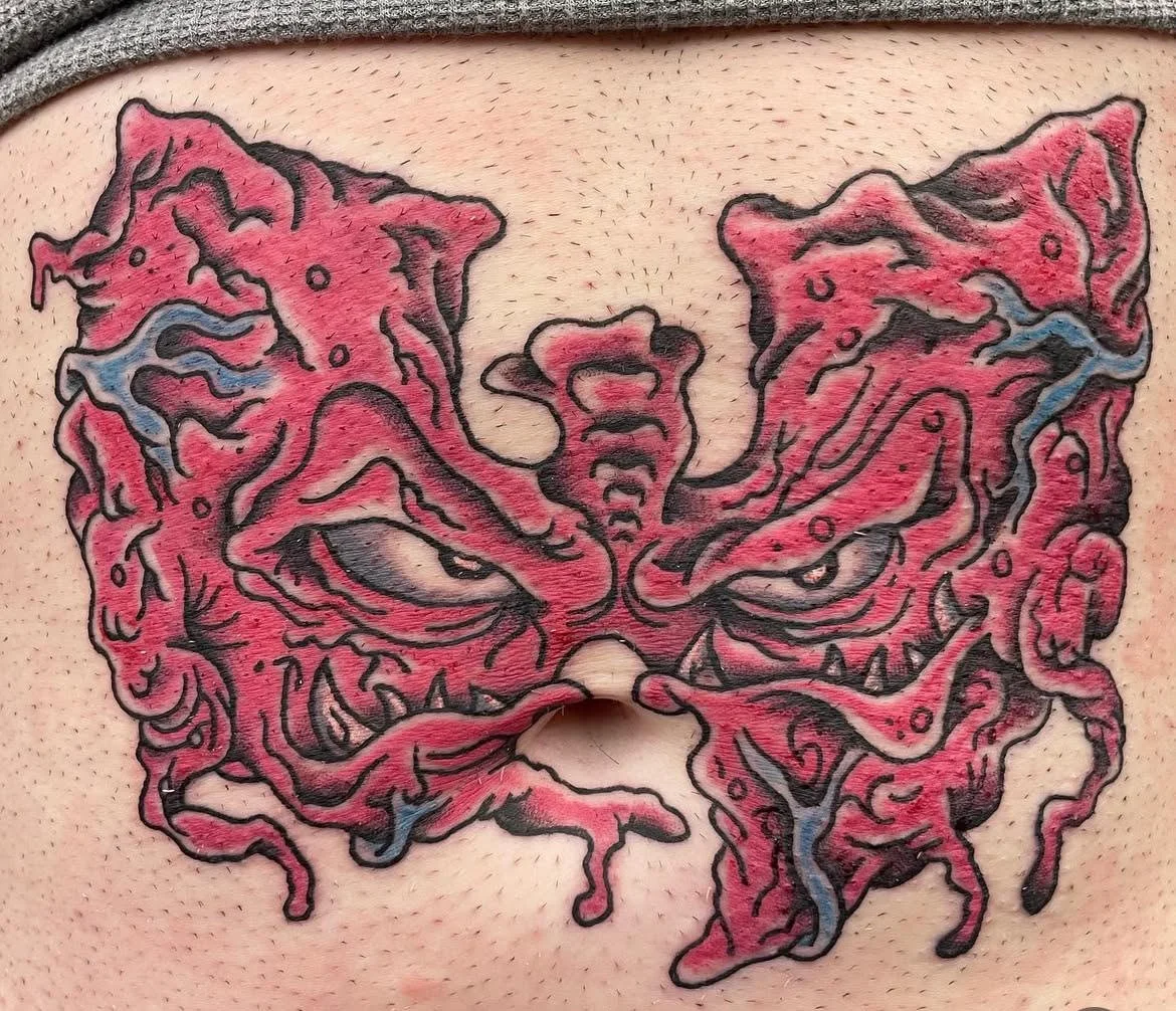 A grotesque, horror-inspired tattoo resembling torn flesh shaped into a mask. The bold texture and gory details make this design stand out as a bold, macabre creation.