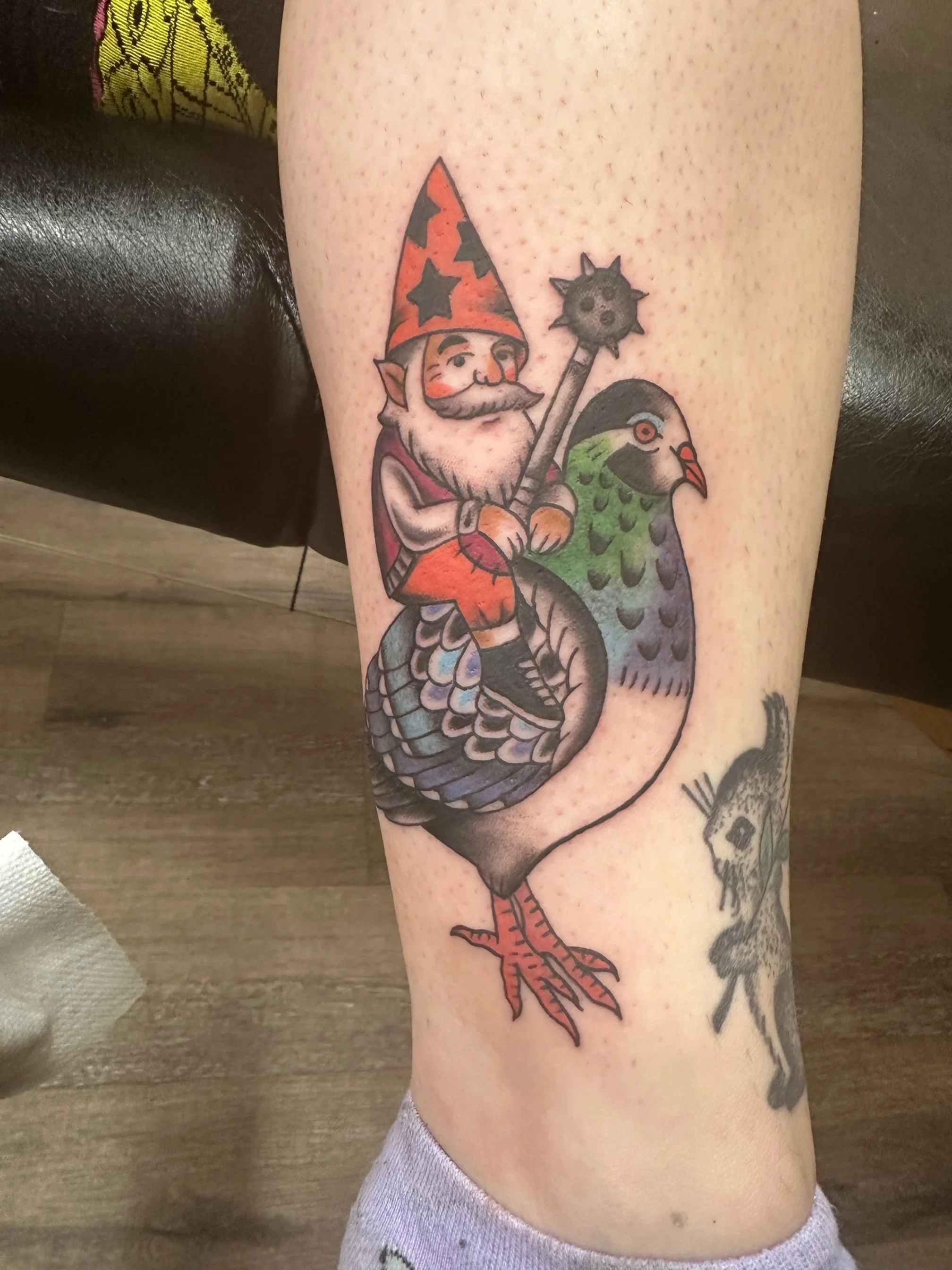 A colorful gnome wielding a spiked mace while riding a pigeon into battle. The playful concept and crisp neo-traditional execution give it a perfect balance of humor and artistry.
