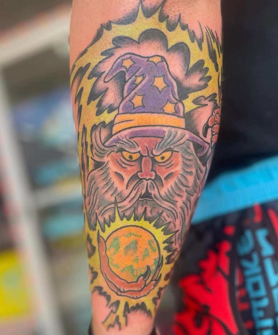 A vivid, old-school wizard surrounded by yellow lightning and mystical energy. The bold linework and saturated hues capture a sense of vintage fantasy and power.