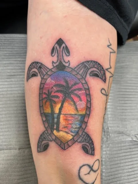A Polynesian-style turtle featuring a vivid sunset scene within its shell. The blend of black geometric patterning and tropical color gradients creates a perfect mix of tradition and relaxation.