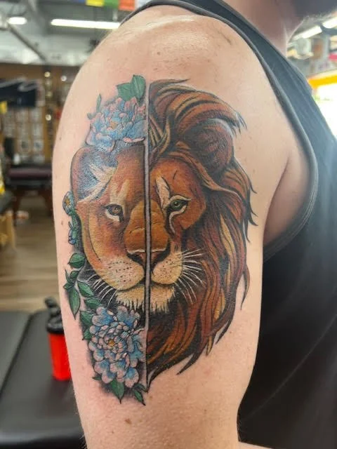 A split lion design featuring one half realistic and the other surrounded by soft blue florals. The composition blends strength and serenity with bold color contrast and balance.
