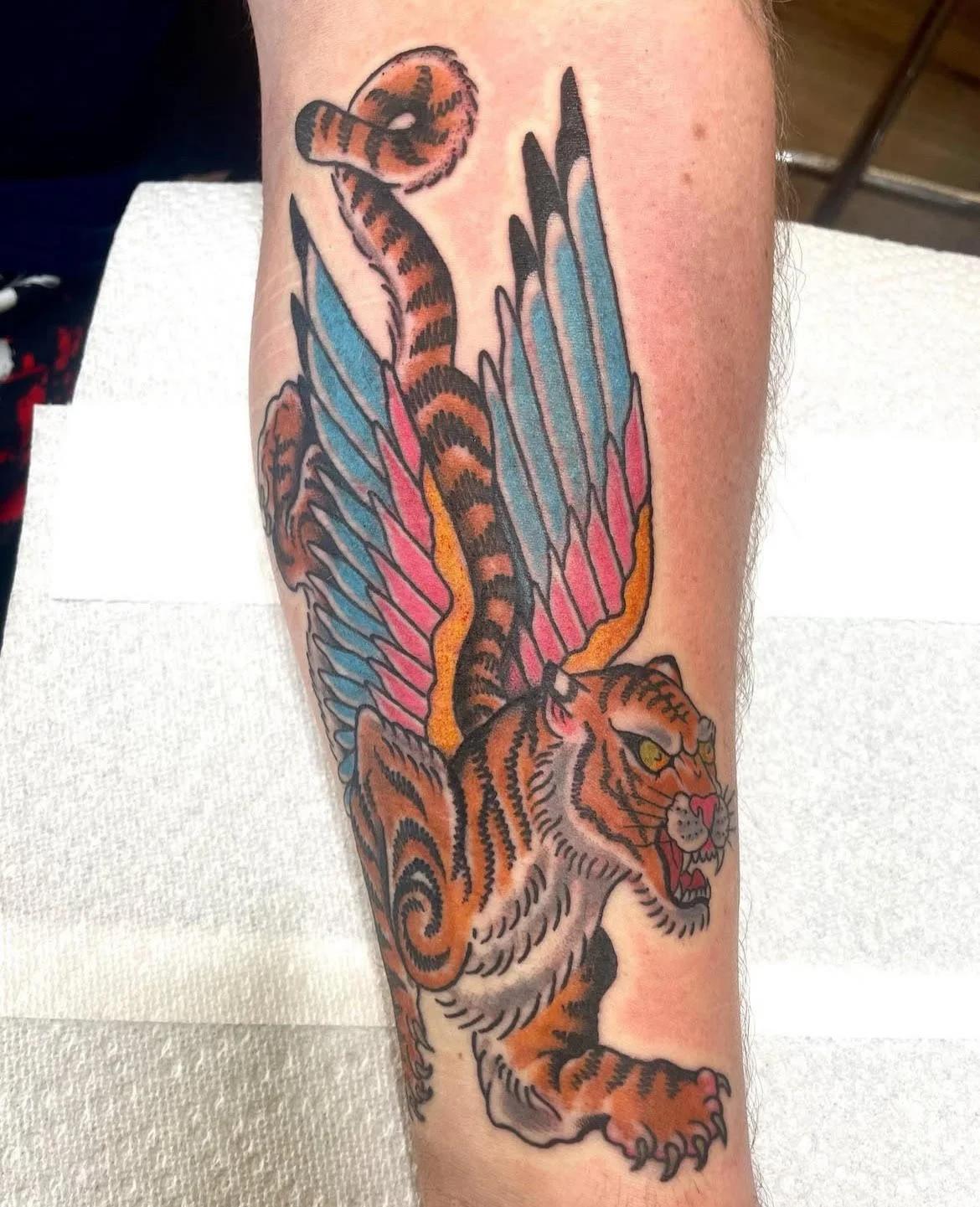 A fantasy-inspired design blending a tiger’s power with a serpent and vibrant wings. The bright colors and hybrid composition create a striking, dynamic piece.
