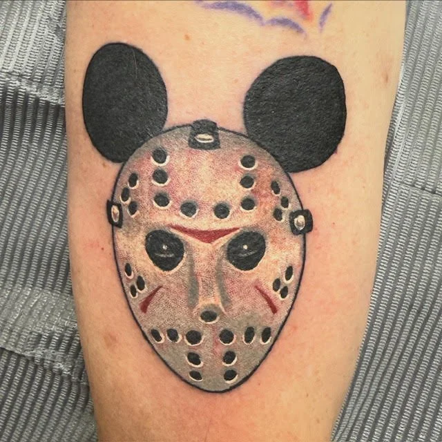 A creative mash-up featuring Jason Voorhees’ hockey mask with Mickey Mouse ears. The mix of horror and pop culture humor gives this piece a unique and unexpected twist.