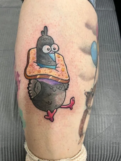 A humorous cartoon pigeon tattoo wearing a toaster pastry as a neckpiece. The bold outlines and soft color tones make it whimsical and eye-catching.