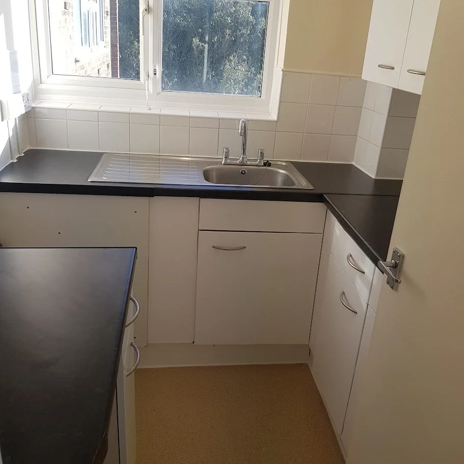 New kitchen units installed during a planned refurbishment programme, including accurate fixing and alignment to Local Authority and Housing Association requirements.
