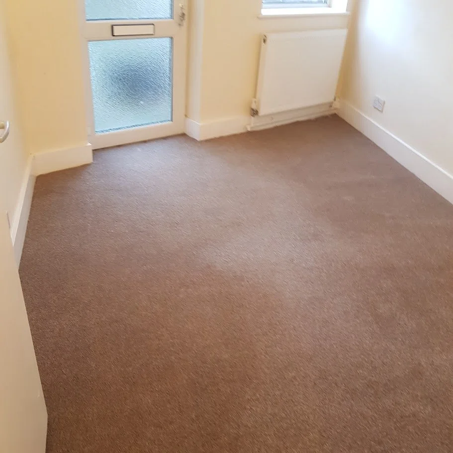 Completed carpet installation to living area following void refurbishment works.