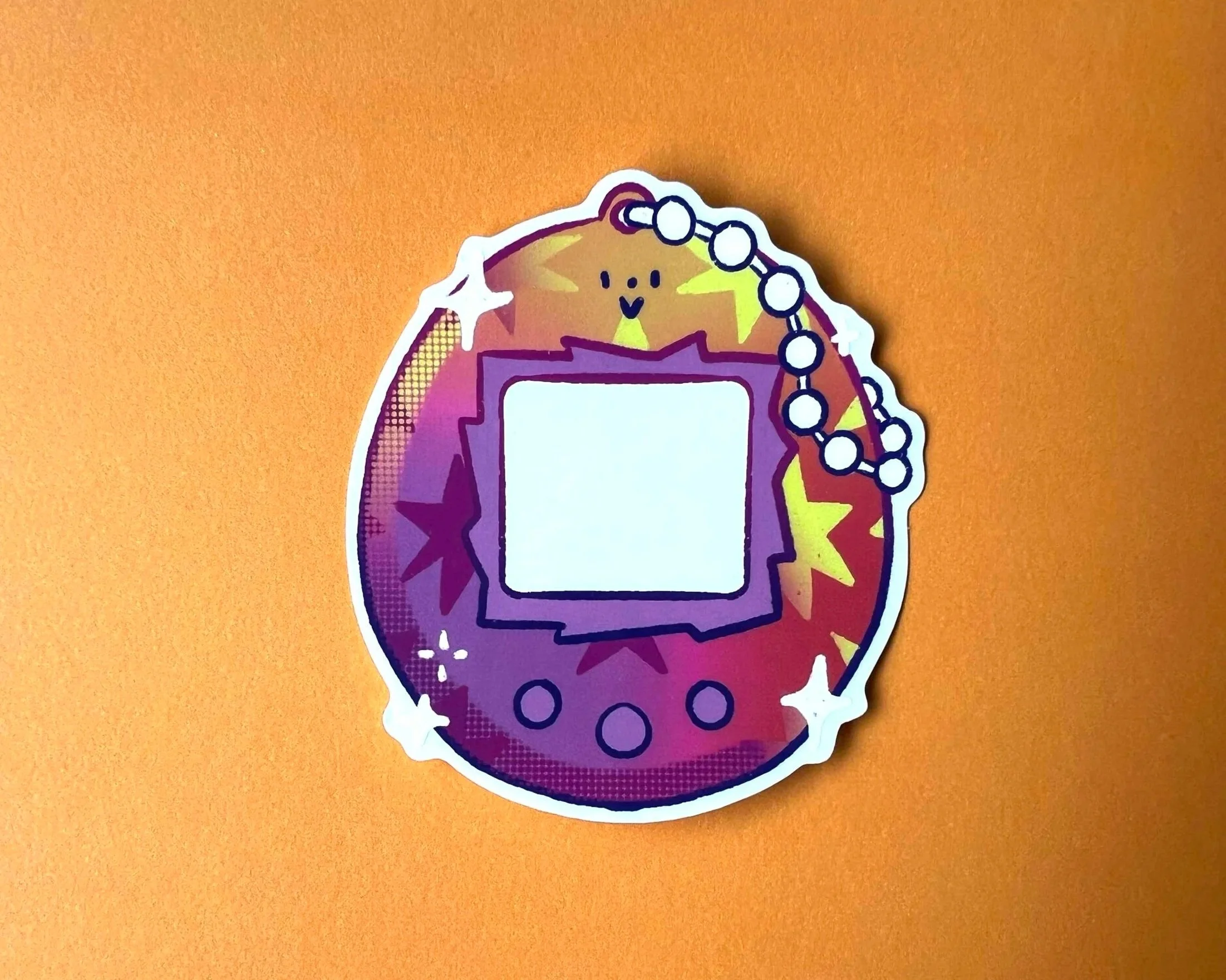 Brightly coloured, illustrated, tamagotchi style vinyl sticker with transparent window for pet photos. 90s retro, pet lover gift ideas