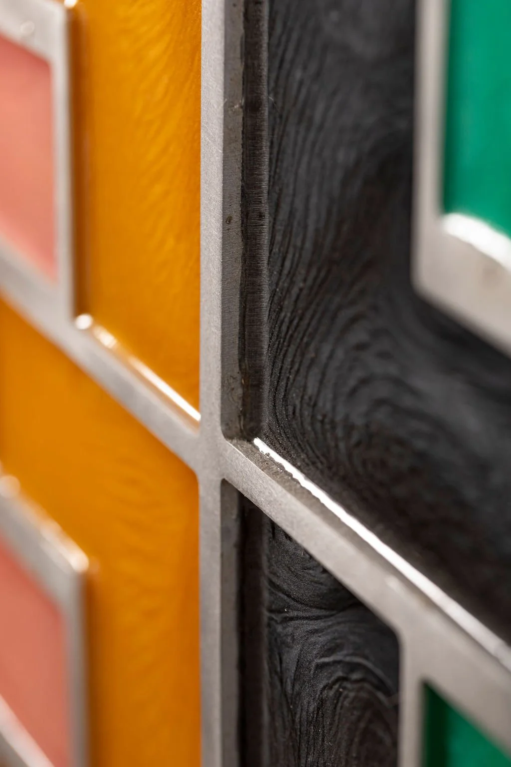 Close-up detail of black and orange resin textures in Colour Current contemporary artwork