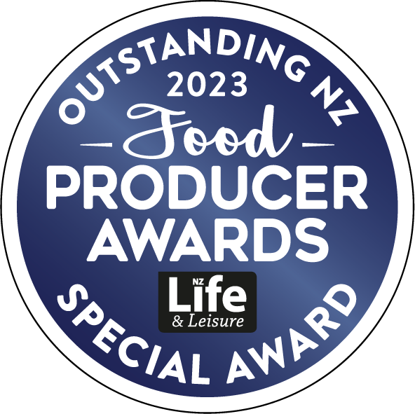 Circular badge with a dark blue background and white border, featuring the text "Outstanding NZ 2023 Food Producer Awards Special Award" and the logo "NZ Life & Leisure" in black and white.