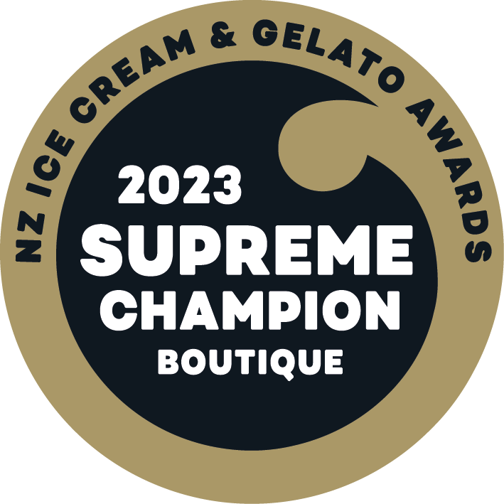 A circular badge with a black center and a gold outer ring. Text on the badge reads '2023 Supreme Champion Boutique' in the center, and around the edge, it says 'NZ Ice Cream & Gelato Awards'.