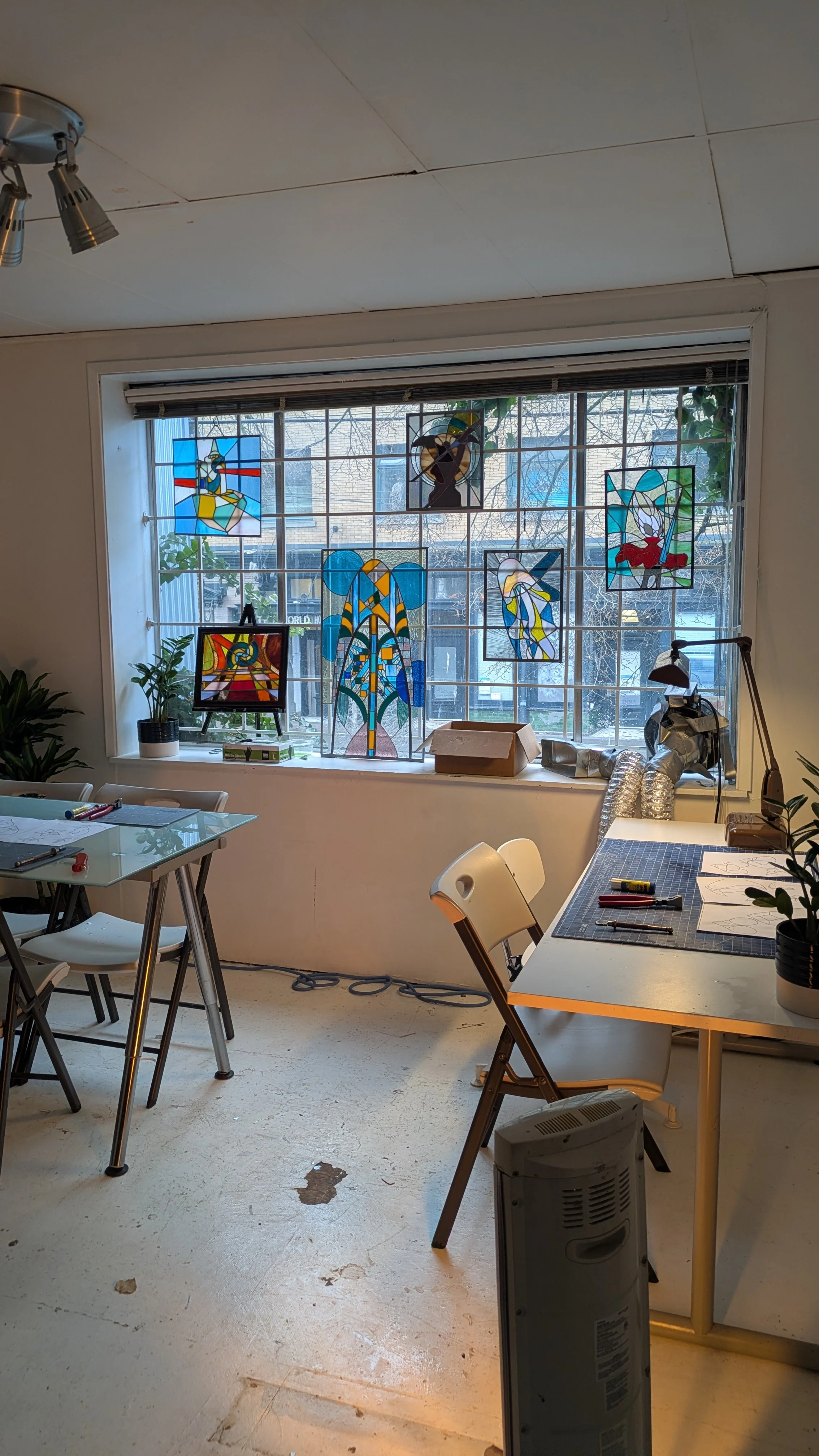 Window with stained glass showing where workshops take place for stained glass in Vancouver's downtown Eastside.