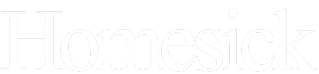The word 'Homesick' written in large white letters on a black background.