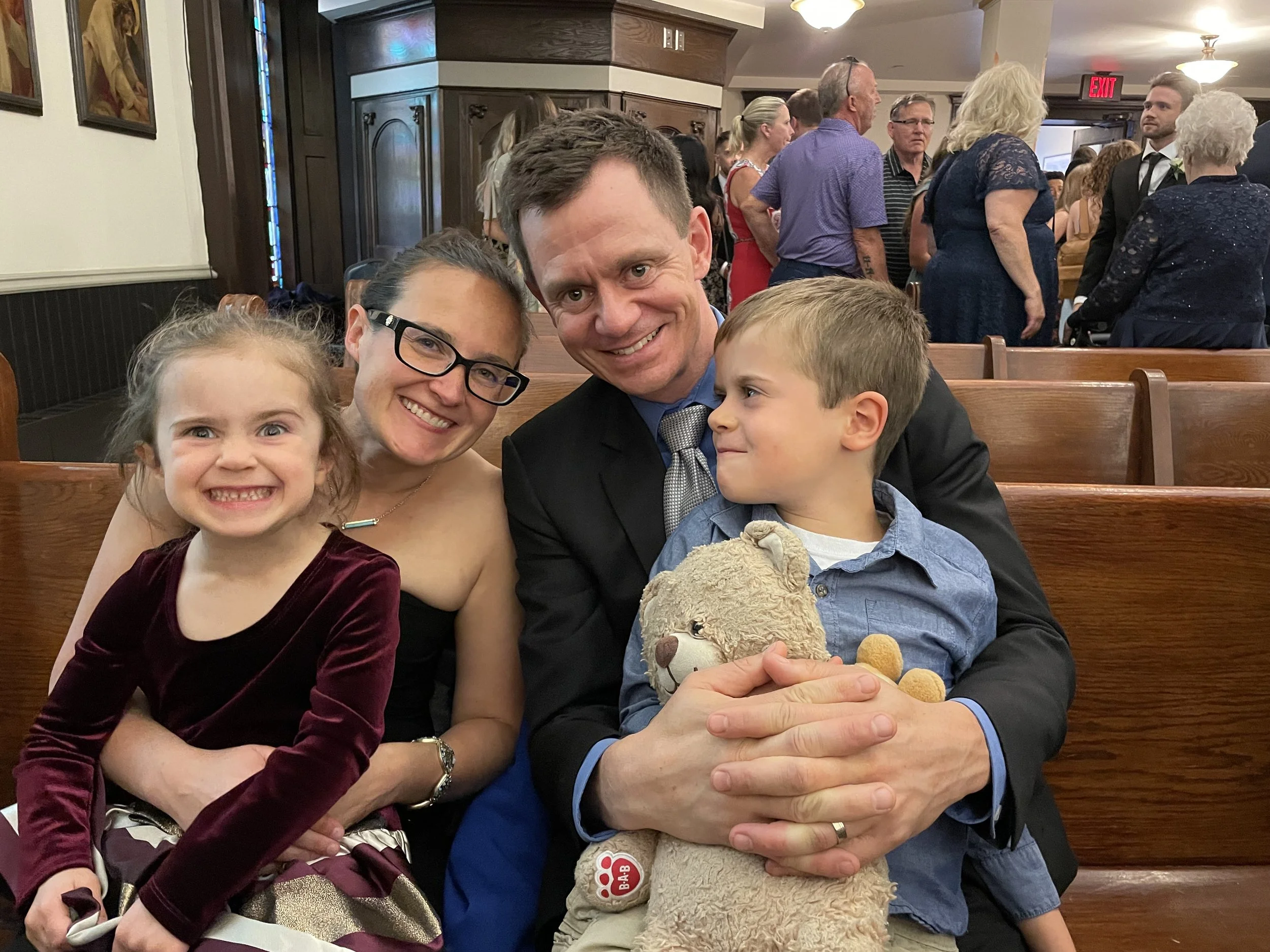 Christos's family sitting, all smiling in a cheerful moment.