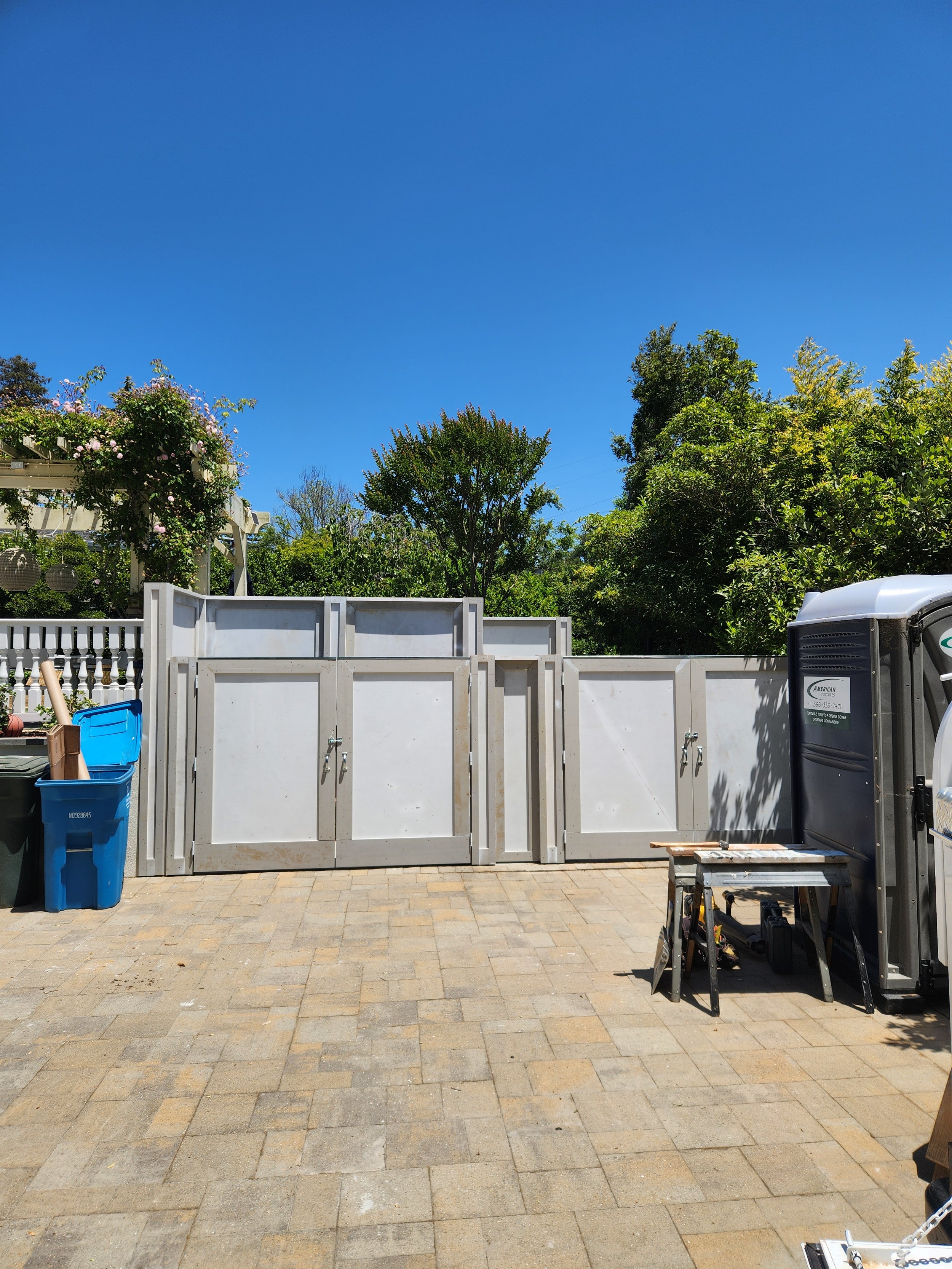 Outdoor trash enclosure featuring square tube steel custom welded gates wrapped with cedar.