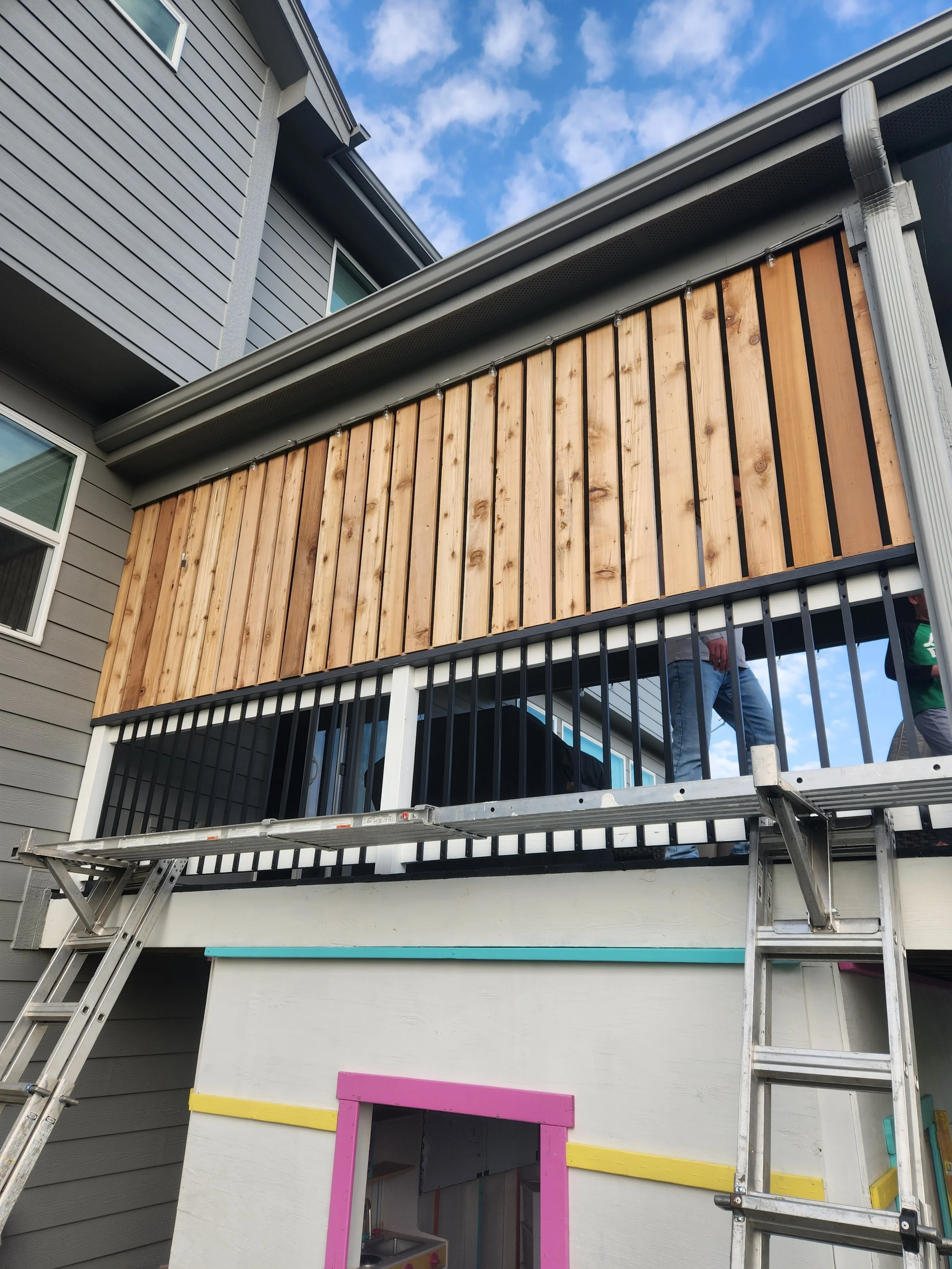 Cedar sun shade and weather barrier built on a deck by Hawkeye Forge and Timber in Des Moines, IA