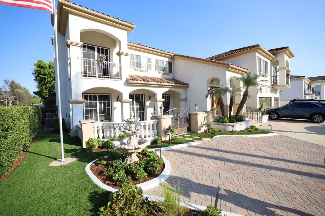 Aerial exterior view of Meadowpass Backlot filming location featuring a two-story house, landscaped surroundings, and production-ready outdoor space.