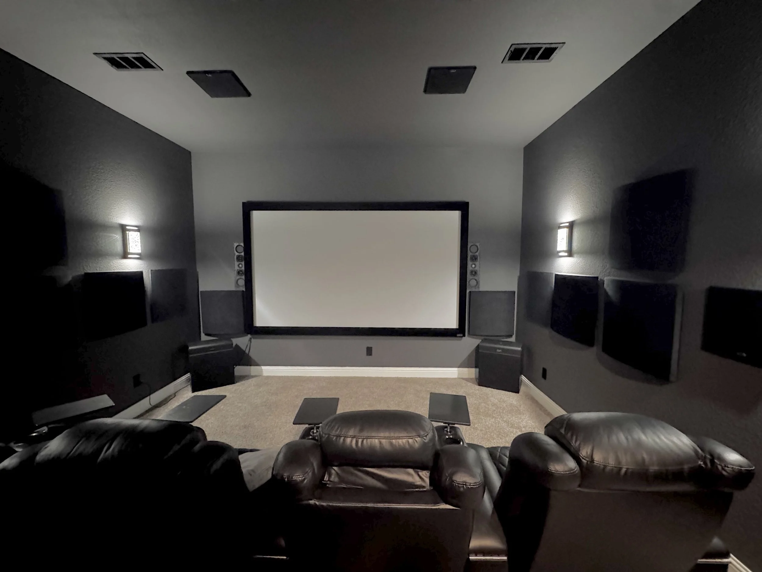 Home theater room projection screen, black leather home theater seating, surround sound speakers, TVs, ceiling speakers, subwoofers, projectors, movies, acoustic soundproofing