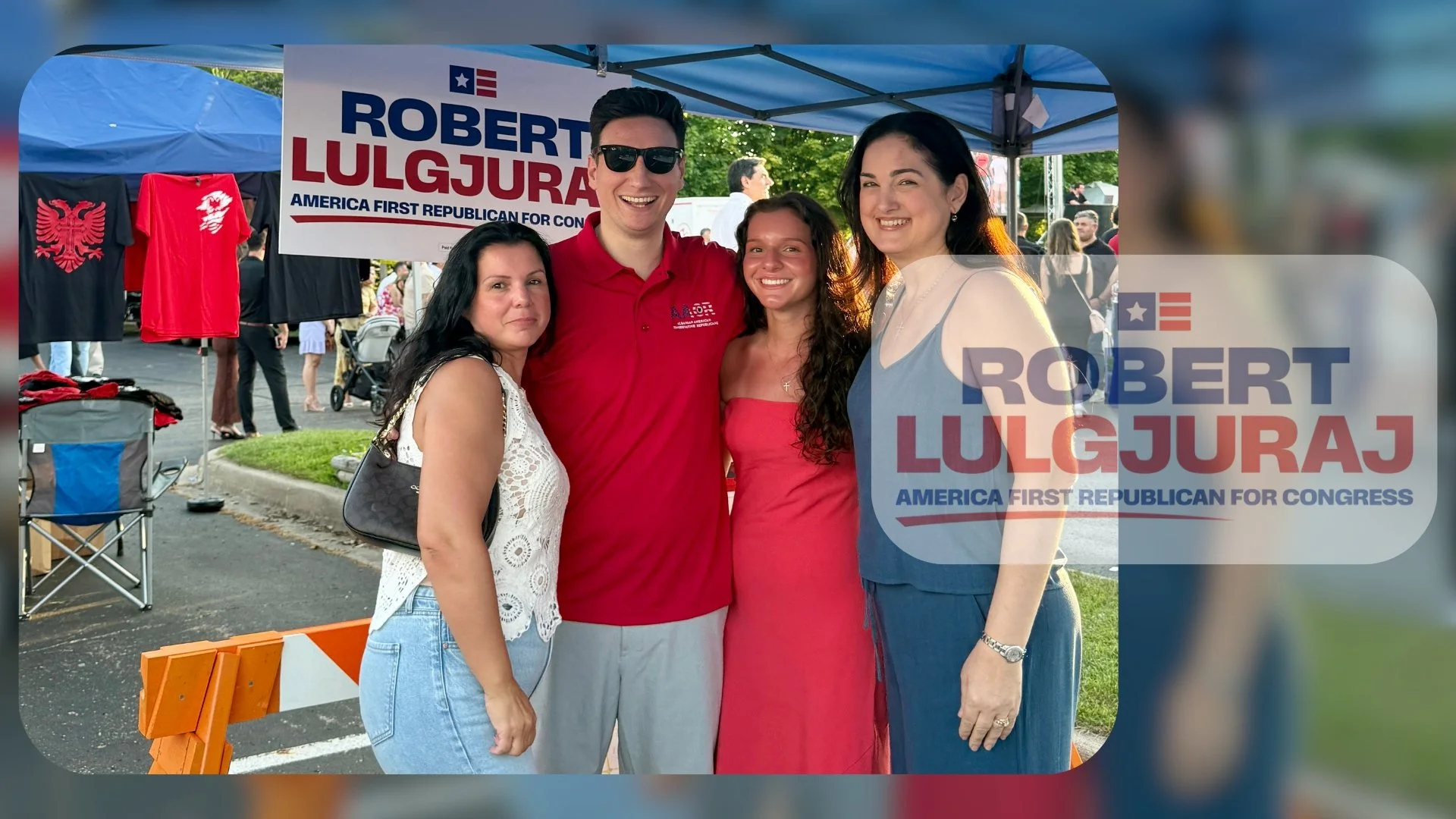 Group of four people outdoors at a political event, standing in front of a blue canopy tent with a sign that reads "Robert Lulgjuraj, America First Republican for Congress." The group includes two women on the left, one man and one woman on the right