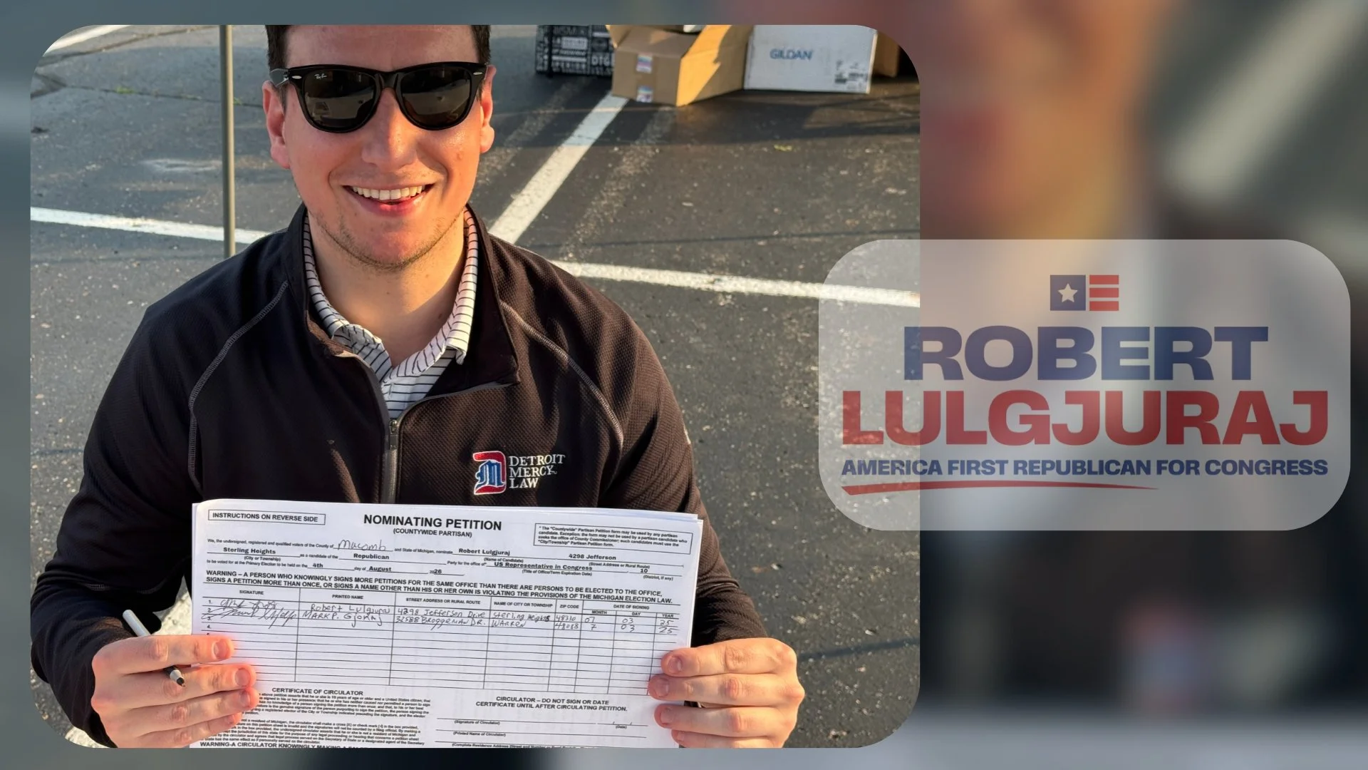 A man wearing sunglasses, a black jacket with a Detroit Mercy Law logo, and a striped shirt holding a nominating petition form in an outdoor parking lot.