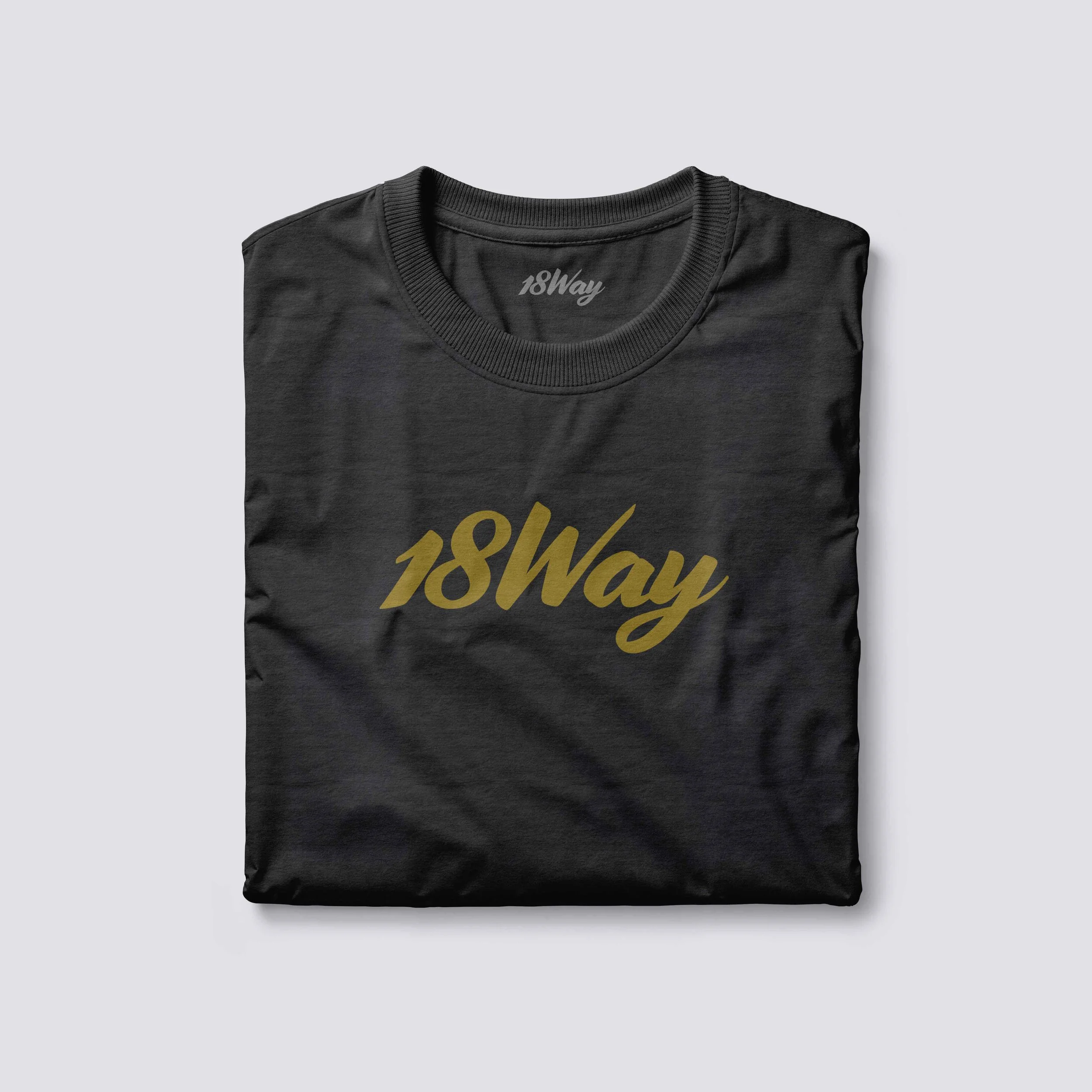Black 18Way t-shirt with gold text reading '18Way' folded and laid flat on a light gray surface.
