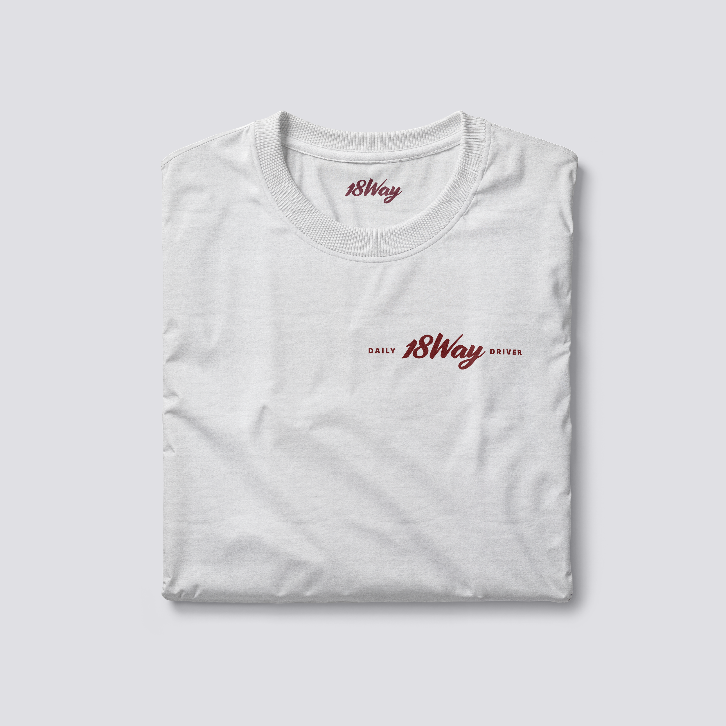 A white T-shirt with the text 'DAILY 18Way DRIVER' in red text on the front.