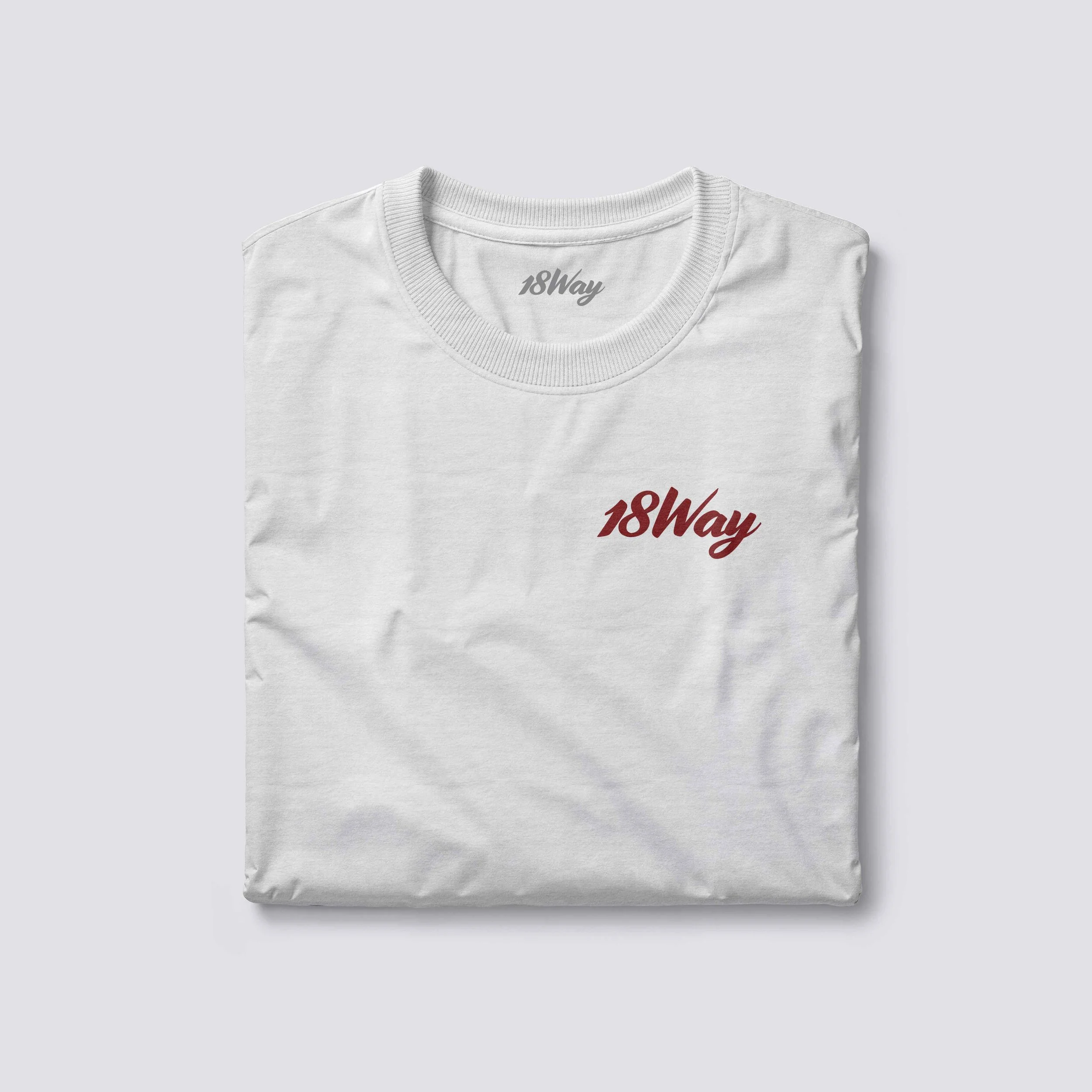 White organic 18Way T-shirt with red and gray '18Way' text printed on the chest, folded and placed on a light gray background.