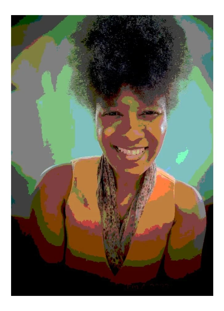 A woman smiling, with natural curly hair, wearing a sleeveless top and a scarf, in front of a colorful, abstract background.