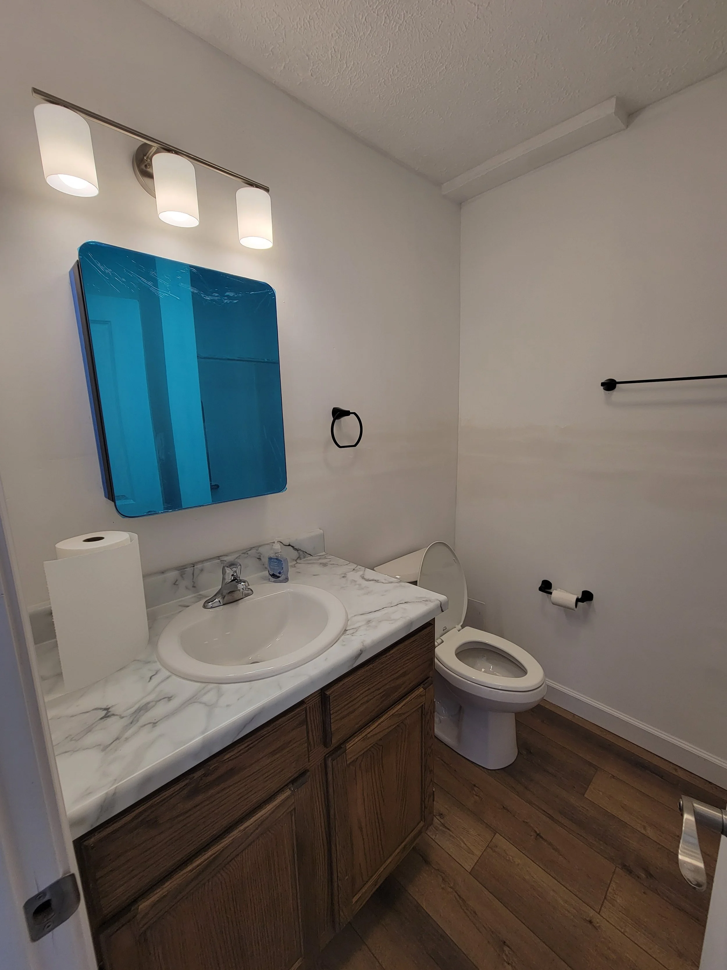 Finished bathroom remodel. New vanity, light fixture, and wood-look LVP flooring. Springfield, IL