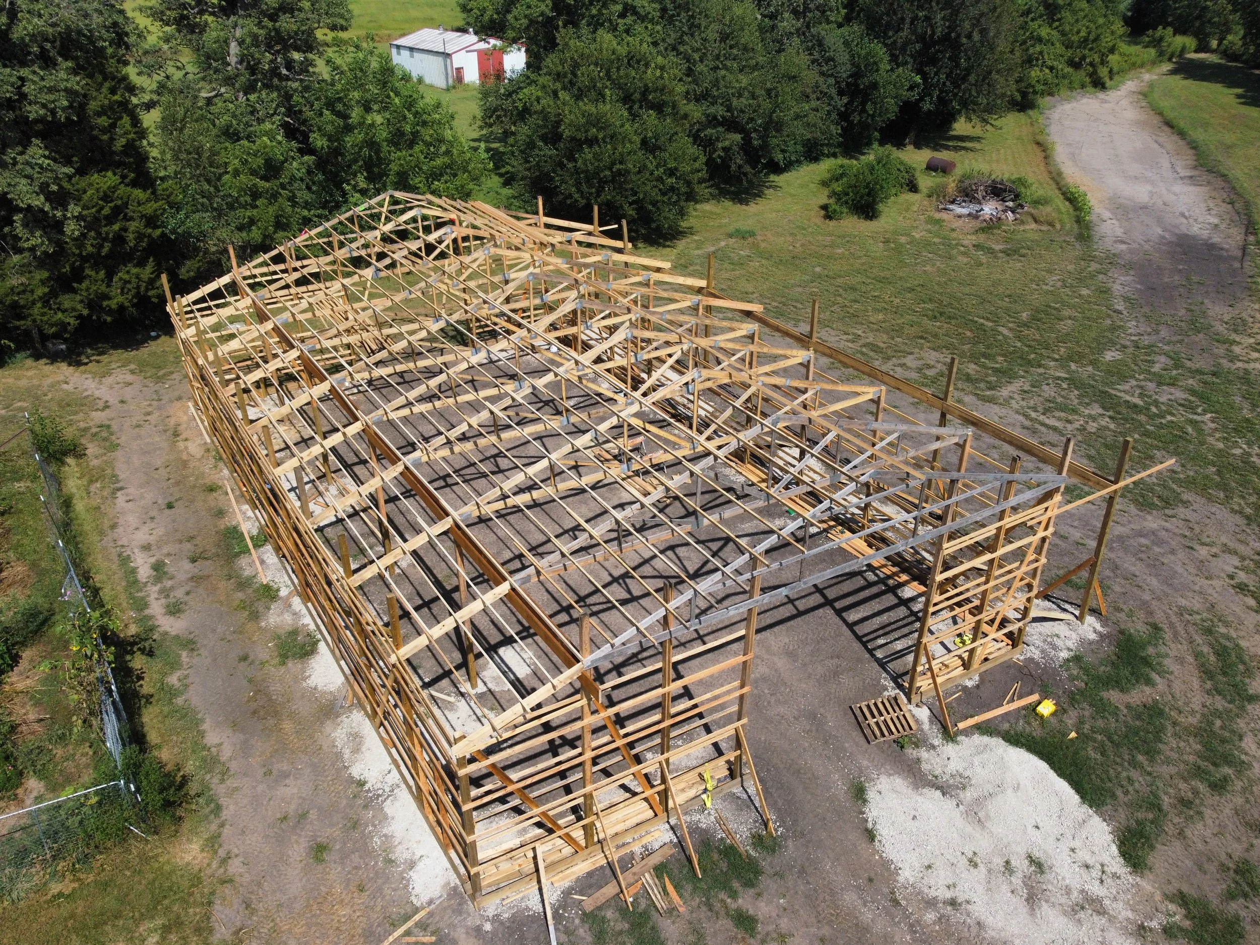 Post-frame building under construction. Aerial view of the roof framing going up. Springfield, IL