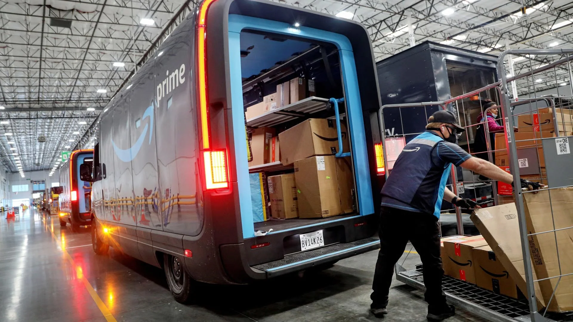 Amazon delivery driver loading packages into a delivery van