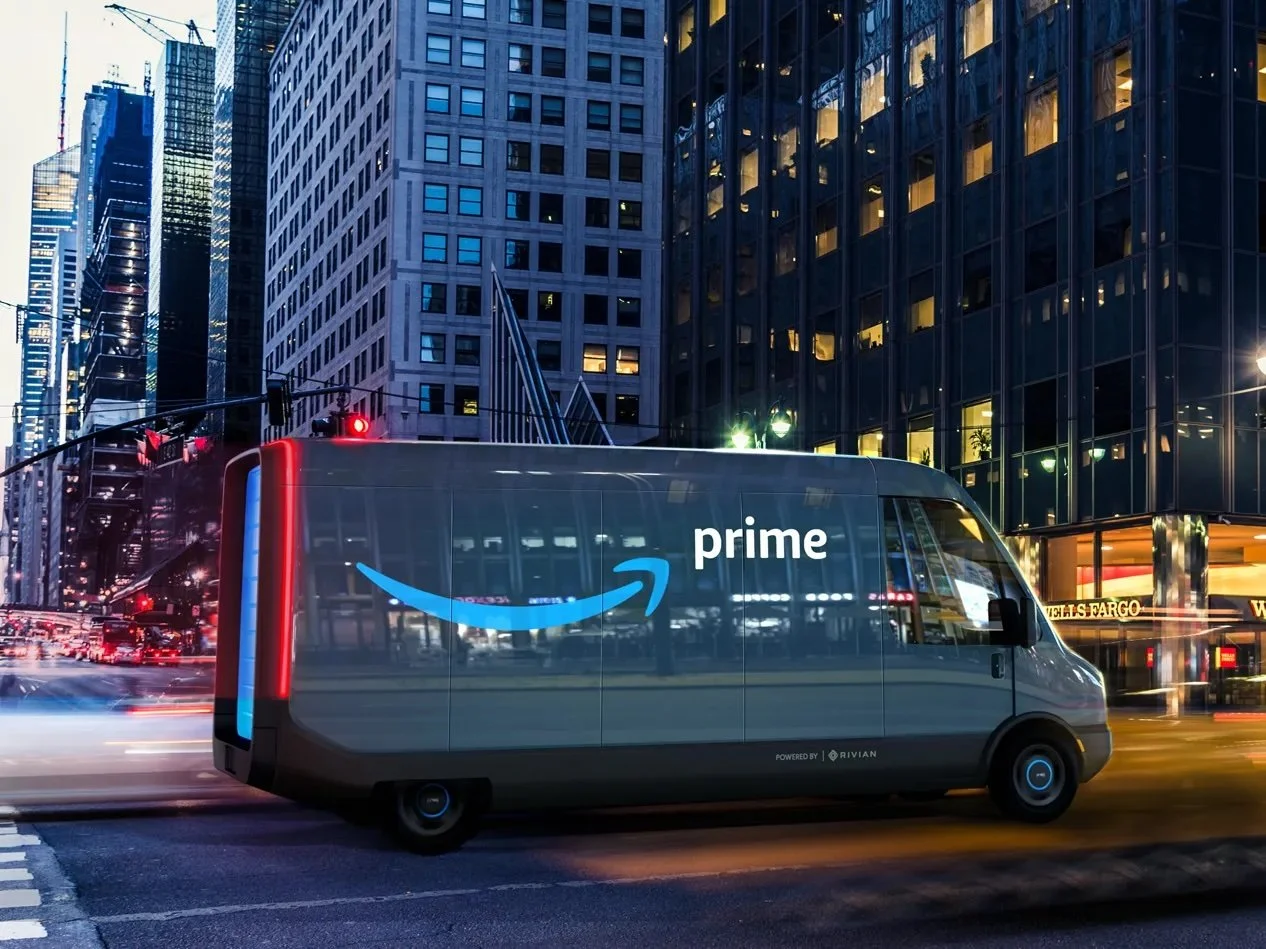 Amazon delivery van driving through a cityscape