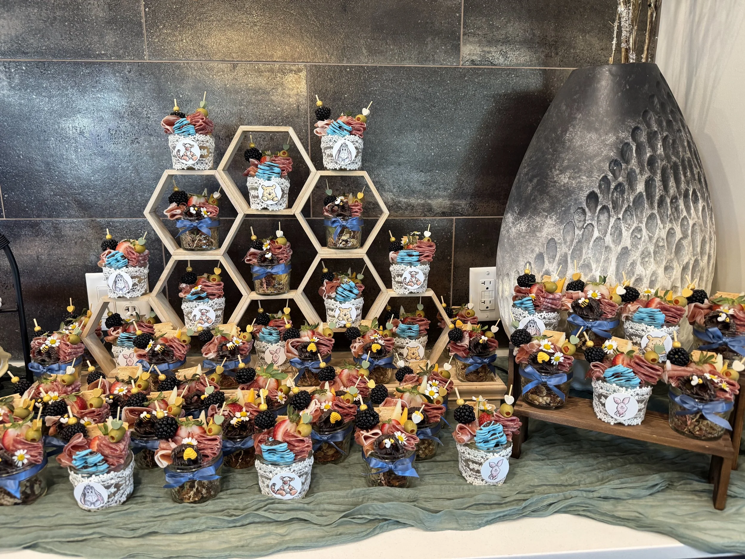 Savory Society Charcuterie Catering for a Baby Shower in St. Louis, Winnie the Pooh themed with glass mason jars and themed decor.