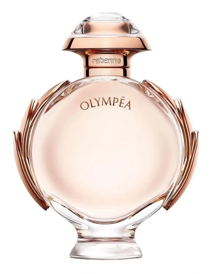A perfume bottle labeled "OLYMPÉA" with a clear, light pink liquid inside, featuring a rounded, transparent glass design and a metallic cap.